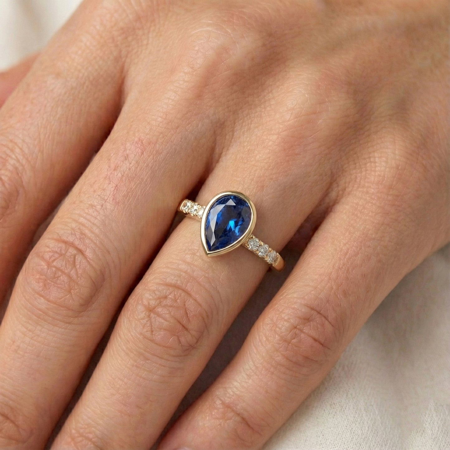 Anniversary Ring Bezel Set Pear Blue Sapphire 2 Carats With Accents